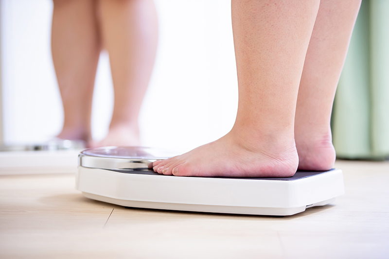 Patient weighs themselves after taking weight management drugs