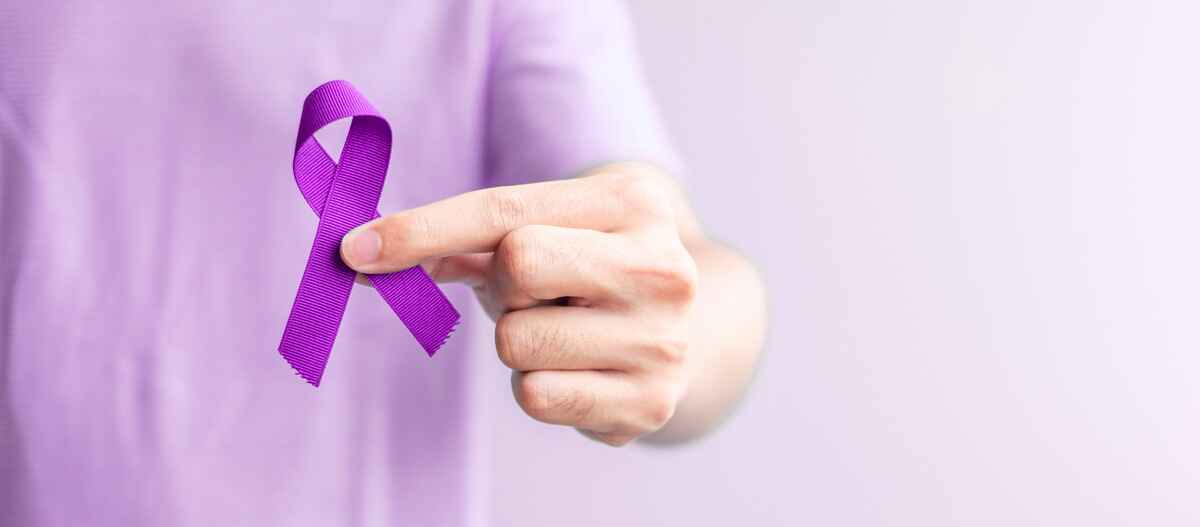 Person holds ribbon representing pancreatic cancer