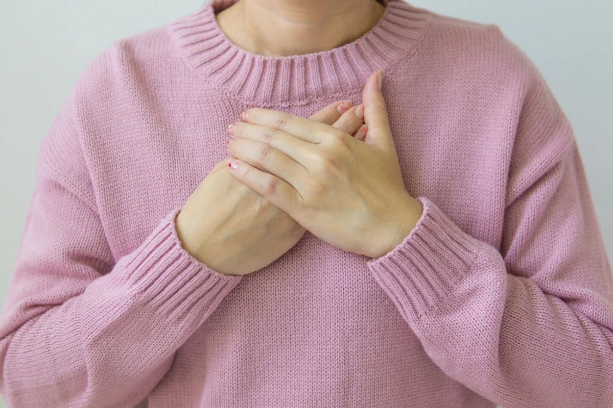Woman holds chest