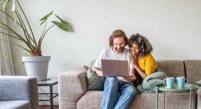 couple sits on the couch together