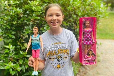 11-year-old Vanessa holding Barbies