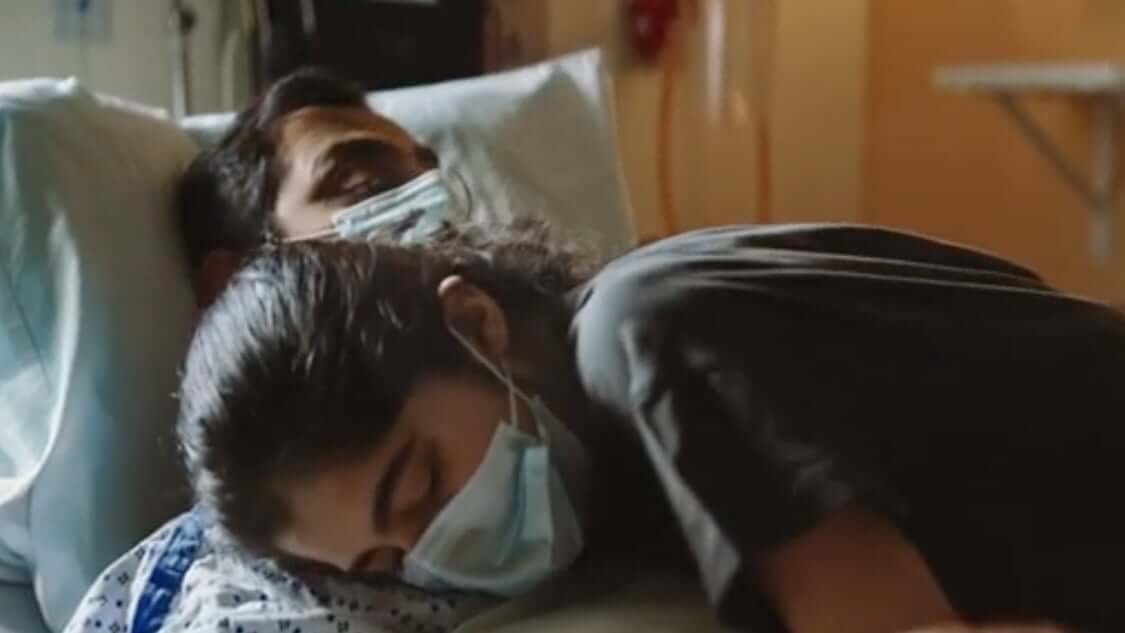 Patient with woman's head on shoulder