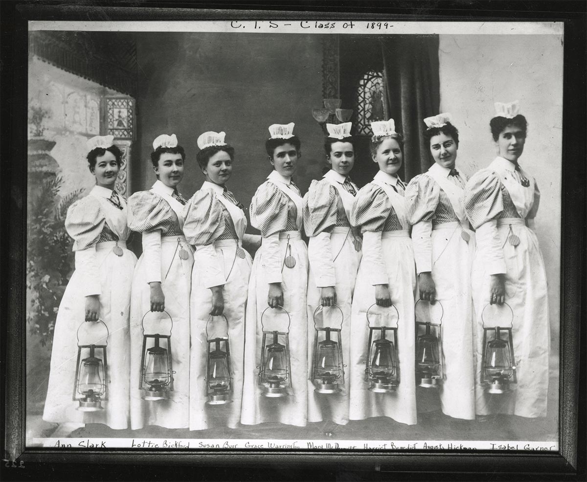Hospital nurses clad in a much earlier version of scrubs used gas lanterns during night rounds, circa 1899.