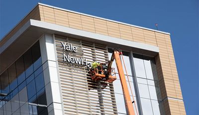 Crews installed the sign for the new Adams Neurosciences Center