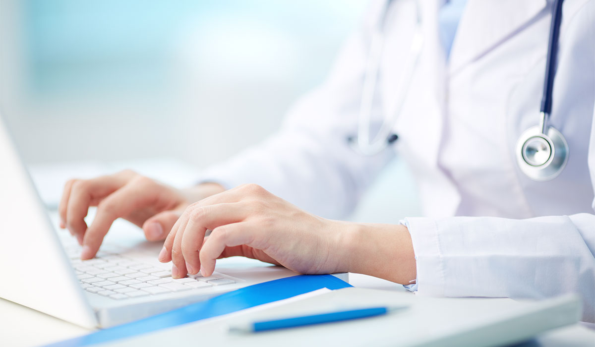 Provider typing on laptop