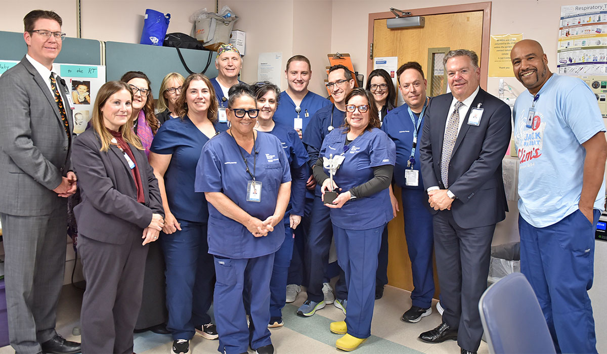 Lisa Chatowsky, RT, (holding trophy) to celebrate her recent PHIL Award