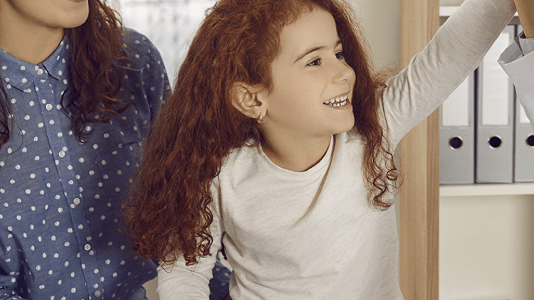 A pediatrician high-fives her patient